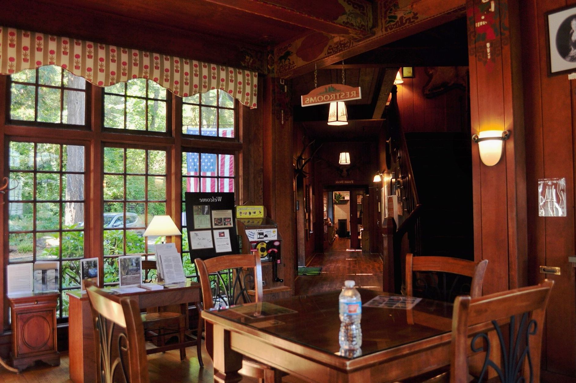 Wood-panelled restaurant interior with pendant lighting and window tables