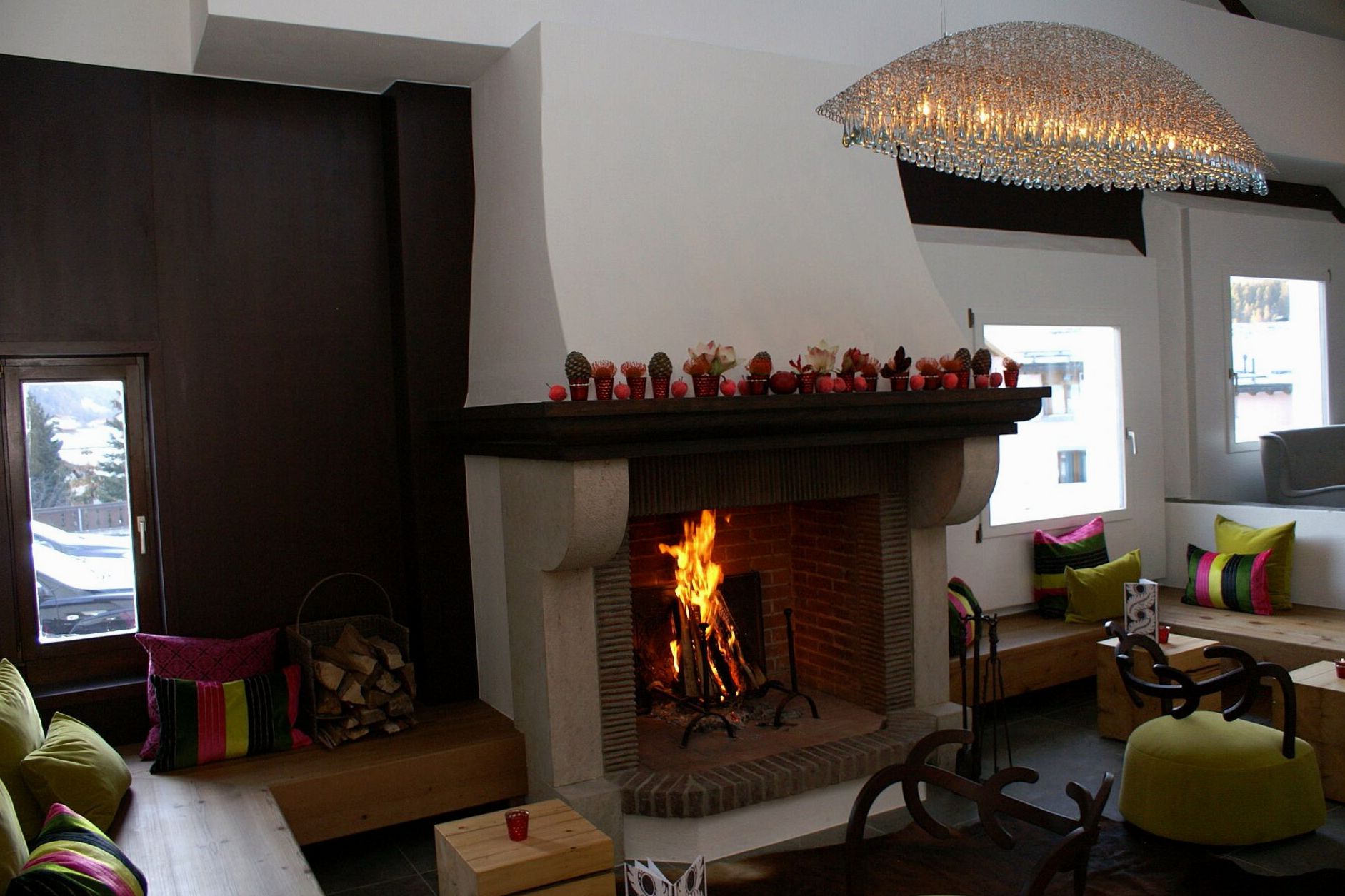 Modern alpine lounge with fireplace, leather armchairs and stone detailing